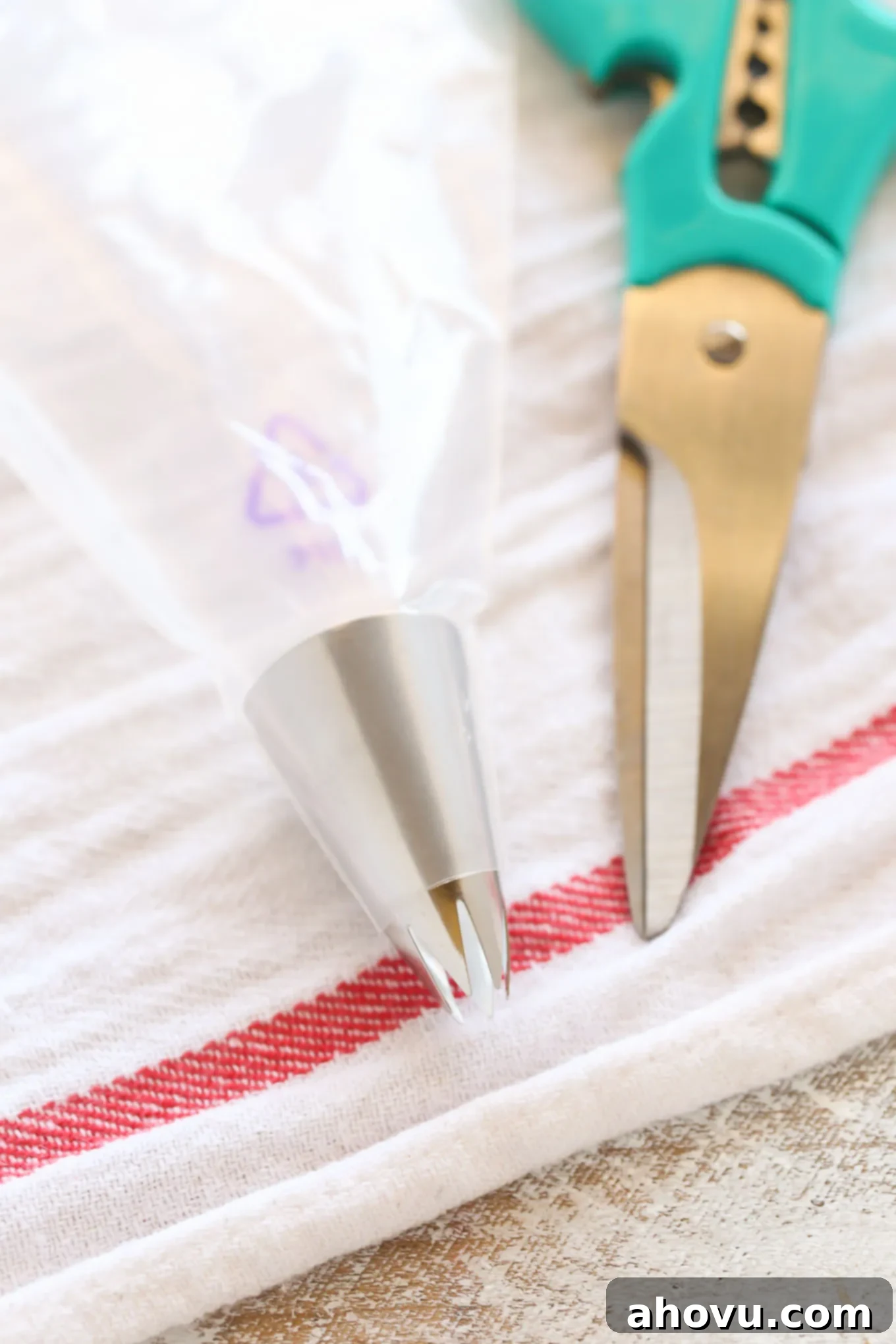 Piping bag prepared with tip inserted for frosting cupcakes