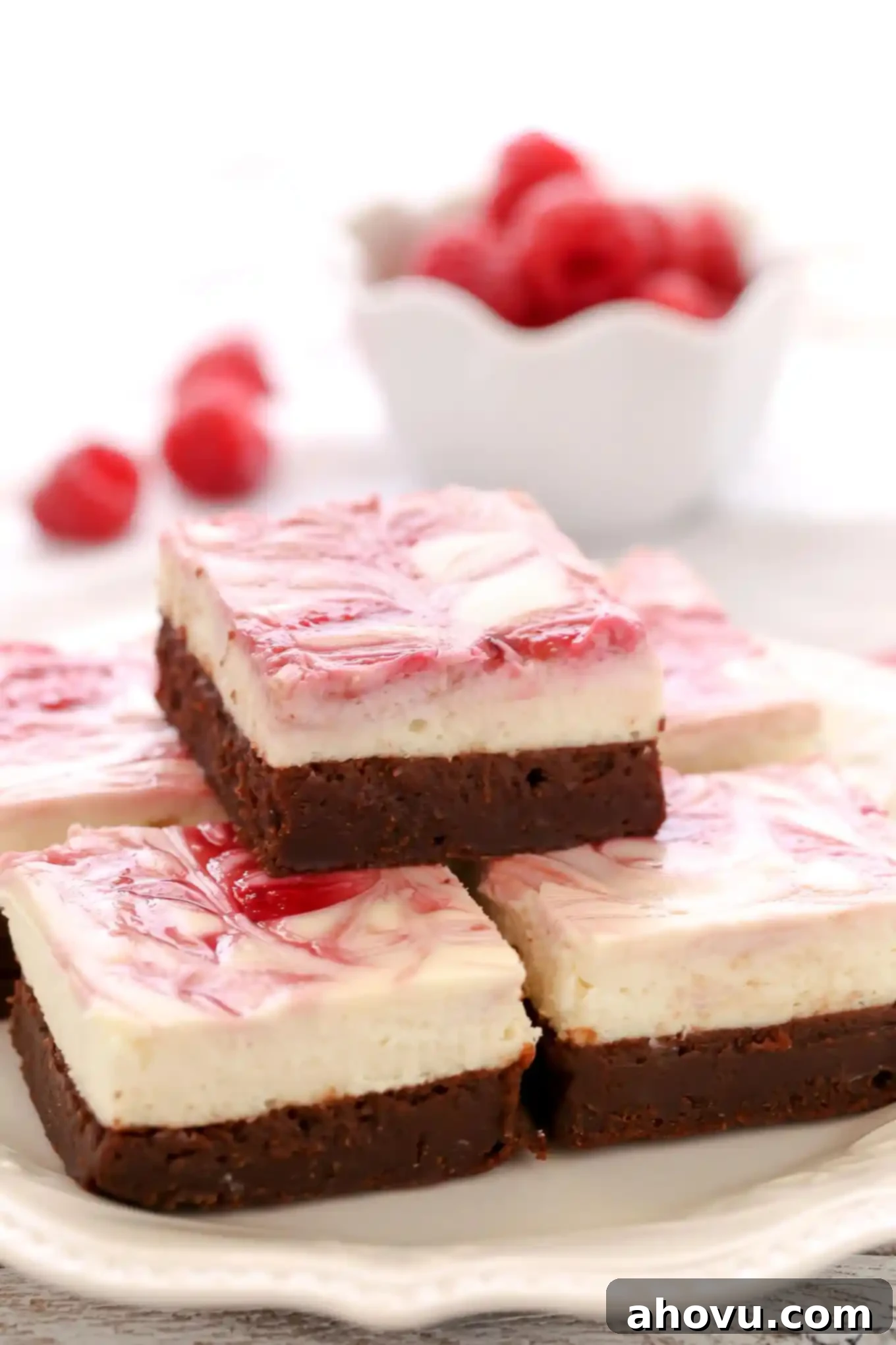 A fudgy brownie base topped with a smooth and creamy cheesecake layer and a raspberry swirl. These Raspberry Cheesecake Brownies make a beautiful dessert for any occasion!