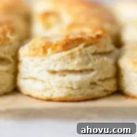 A close-up view of buttermilk biscuits on a baking sheet.