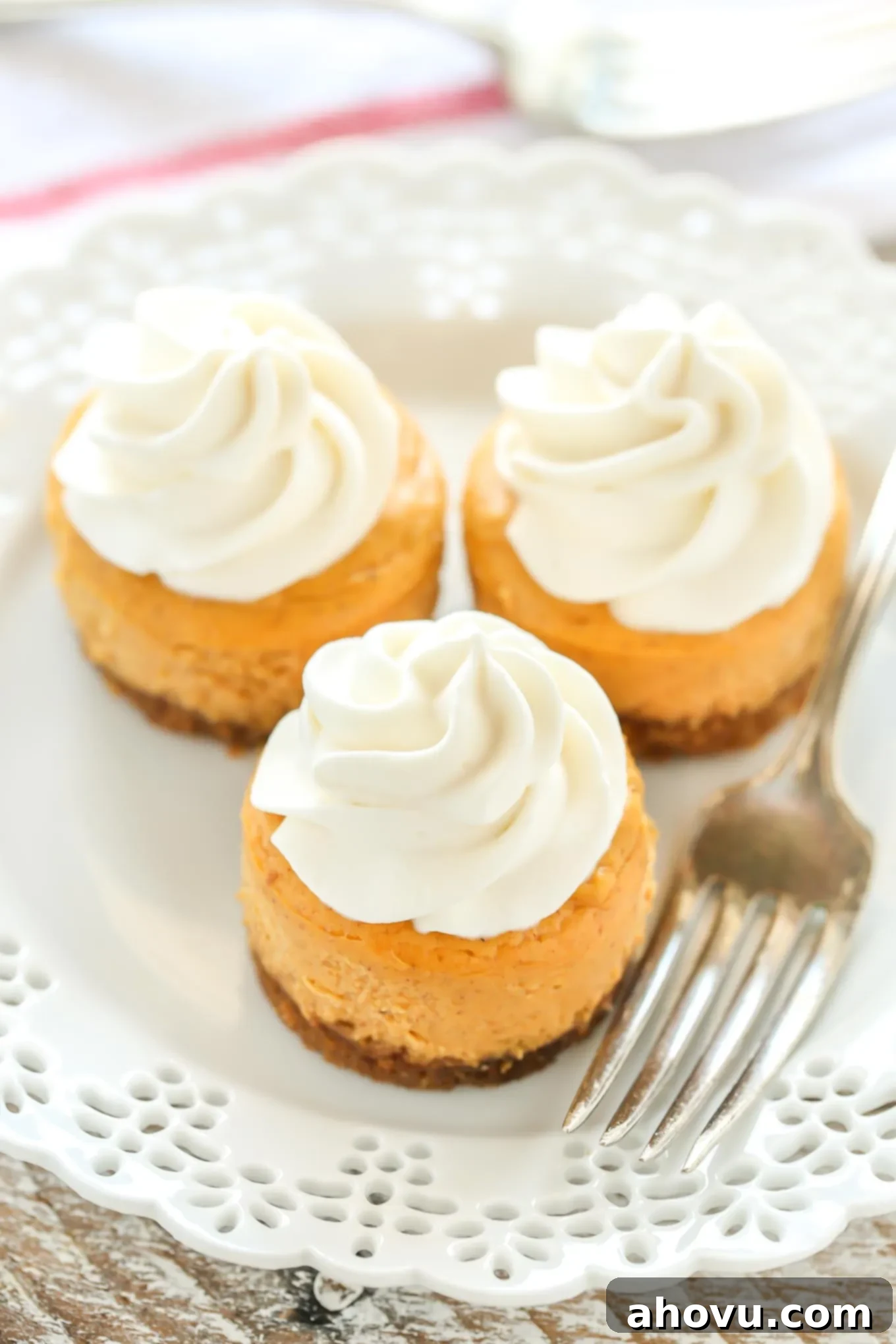 These Mini Pumpkin Cheesecakes feature an easy three ingredient gingersnap cookie crust with a smooth and creamy pumpkin cheesecake filling on top. These are the perfect mini dessert for fall!