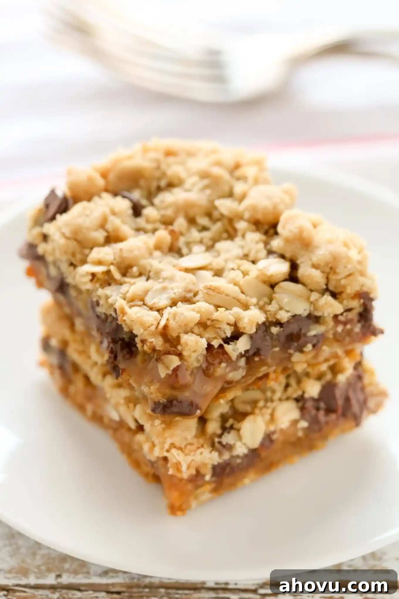 The Carmelitas 3 Two carmelitas stacked on a white plate. A fork rests on a tea towel in the background.