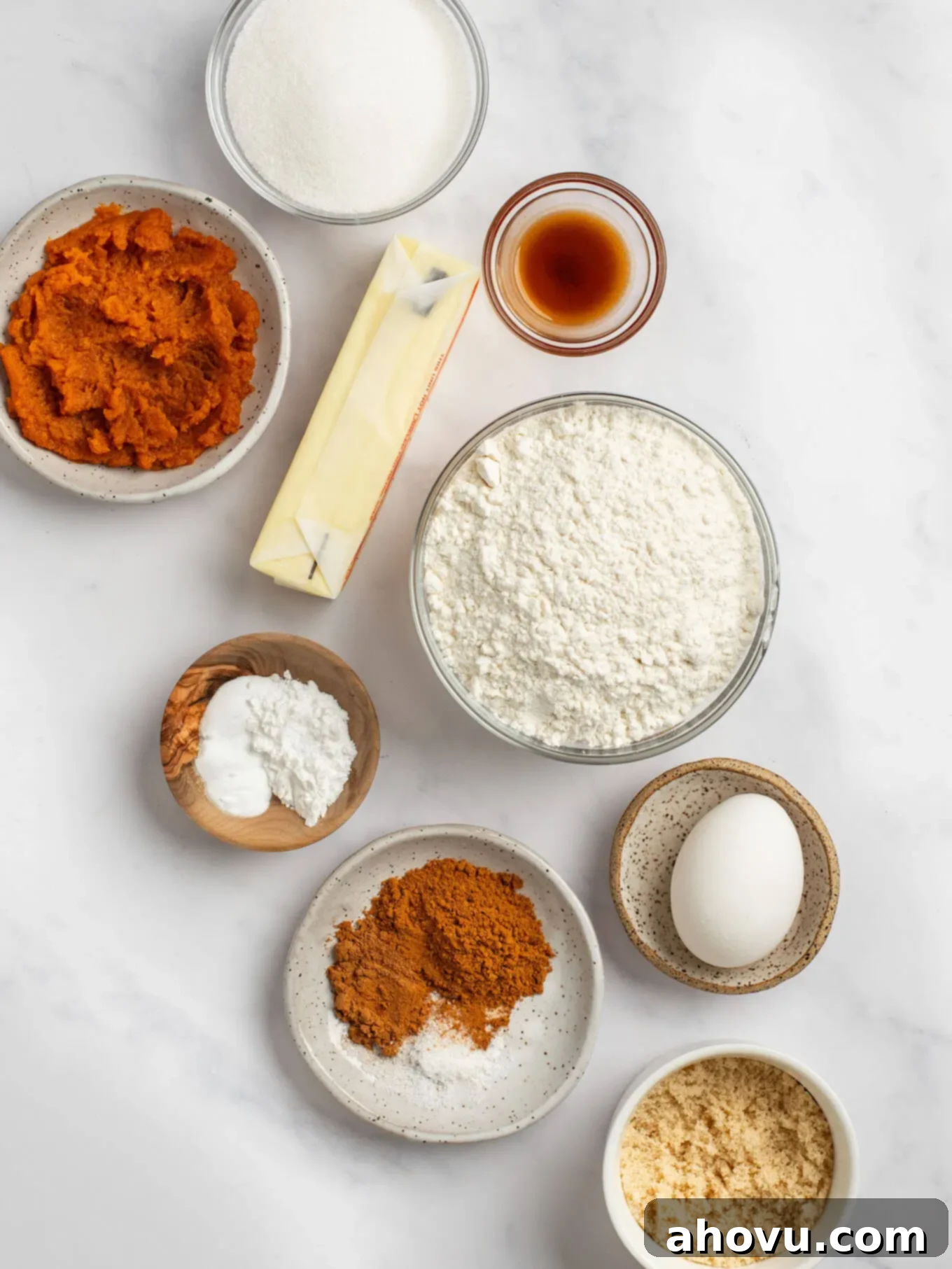 Spiced Pumpkin Snickerdoodles 3 An overhead view of all the essential ingredients meticulously laid out for baking a batch of delicious pumpkin snickerdoodles, including flour, sugars, spices, and pumpkin puree.