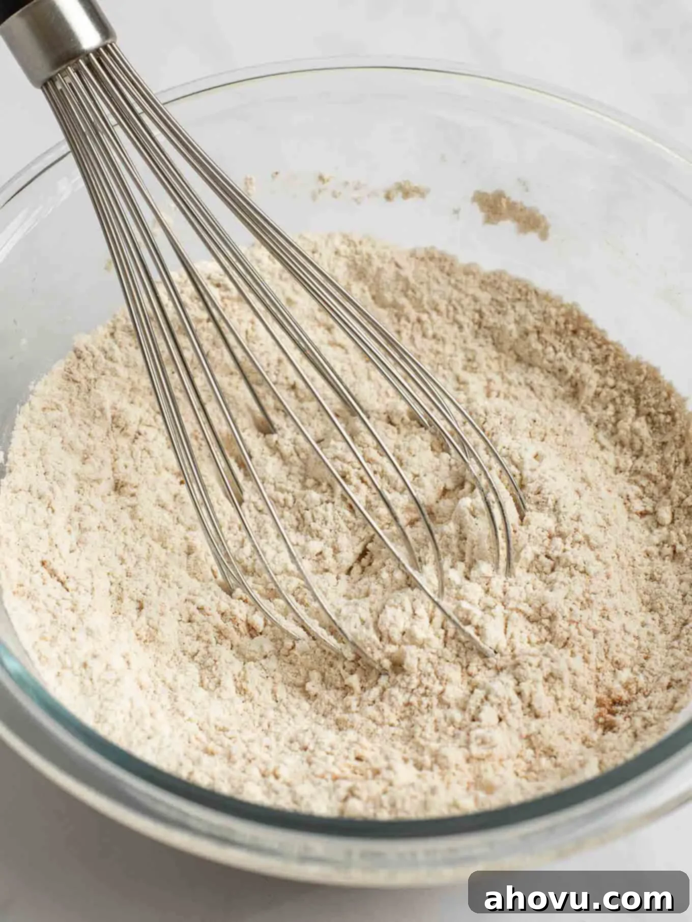 Spiced Pumpkin Snickerdoodles 4 Flour, pumpkin pie spice, ground cinnamon, baking soda, cream of tartar, and salt are perfectly whisked together in a clear glass mixing bowl, forming the dry ingredient mixture for pumpkin snickerdoodles.