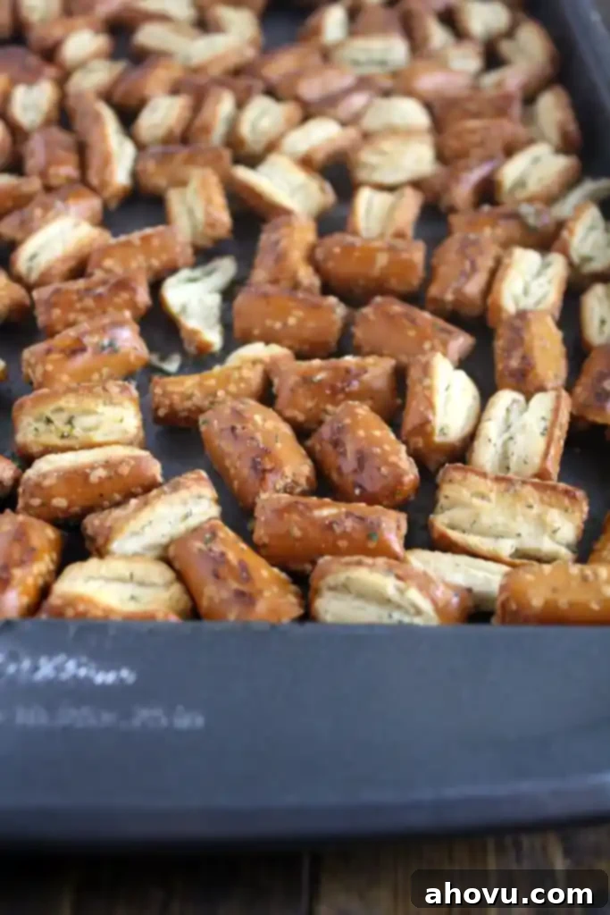 Savory Seasoned Pretzels 3 Ranch seasoned pretzels spread out on a baking tray after being seasoned.