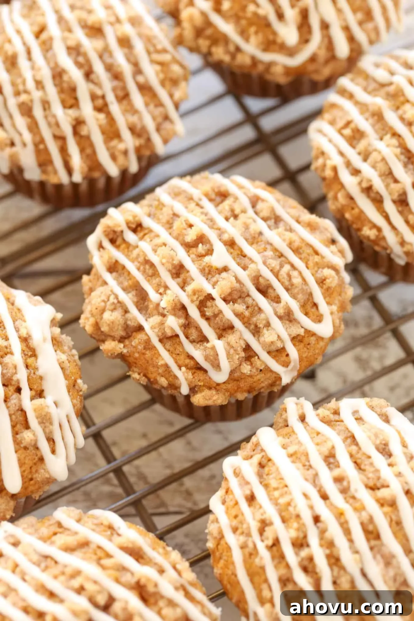 Glazed pumpkin muffins on a cooling rack, showing their perfectly baked tops and delicious glaze.