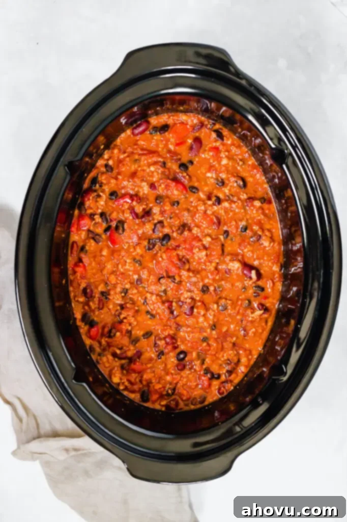An overhead view of a crockpot filled with homemade turkey chili.