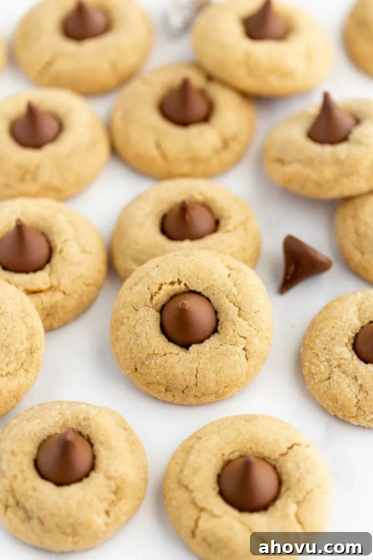 Grandma's Peanut Butter Blossoms 2 A baking sheet covered in peanut butter blossoms with chocolate kisses mixed in.