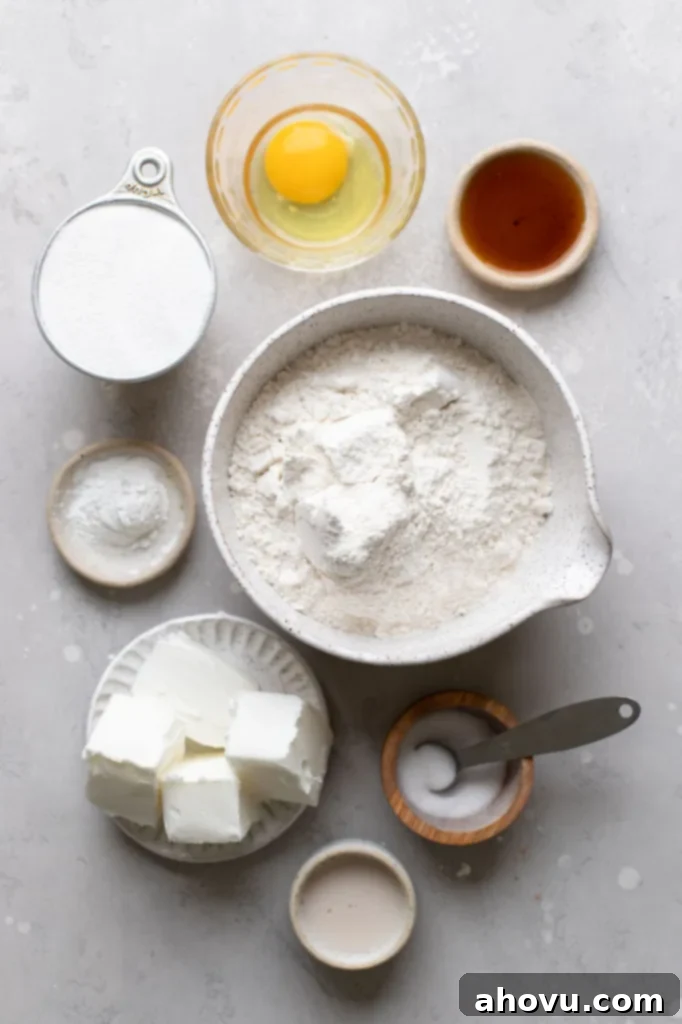 Perfect Cut Out Sugar Cookies 3 All the necessary ingredients for making cut-out sugar cookies, neatly arranged on a rustic gray background.