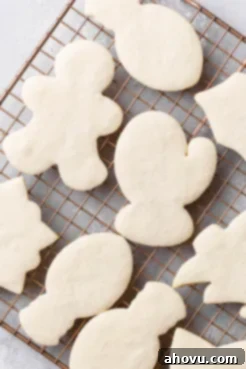 A cooling rack displays freshly baked cut-out sugar cookies, cooling down before they are ready for icing and decoration.