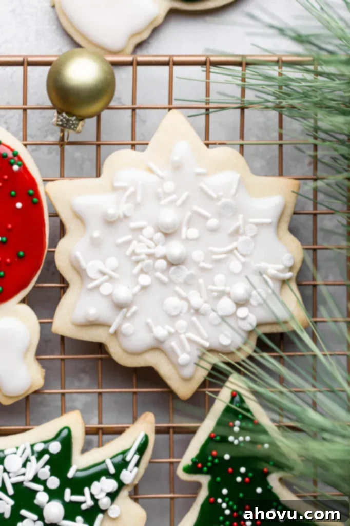 Perfect Cut Out Sugar Cookies 5 A close-up shot of beautifully decorated cut-out sugar cookies, showcasing intricate icing details on a cooling rack.