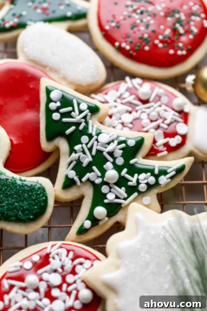 Perfect Cut Out Sugar Cookies 6 A cooling rack is adorned with an assortment of festive, decorated Christmas sugar cookies, ready for holiday celebrations.