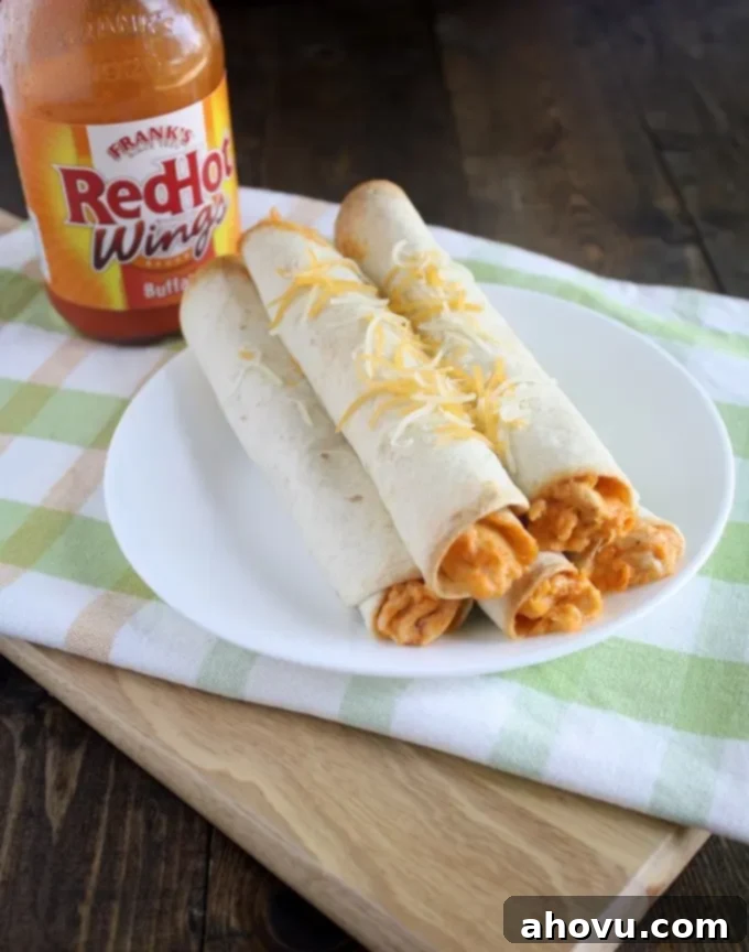 Up-close shot of golden-brown Buffalo Chicken Taquitos