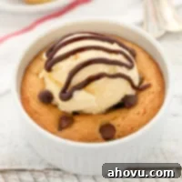 A deep dish single serve chocolate chip cookie topped with ice cream.
