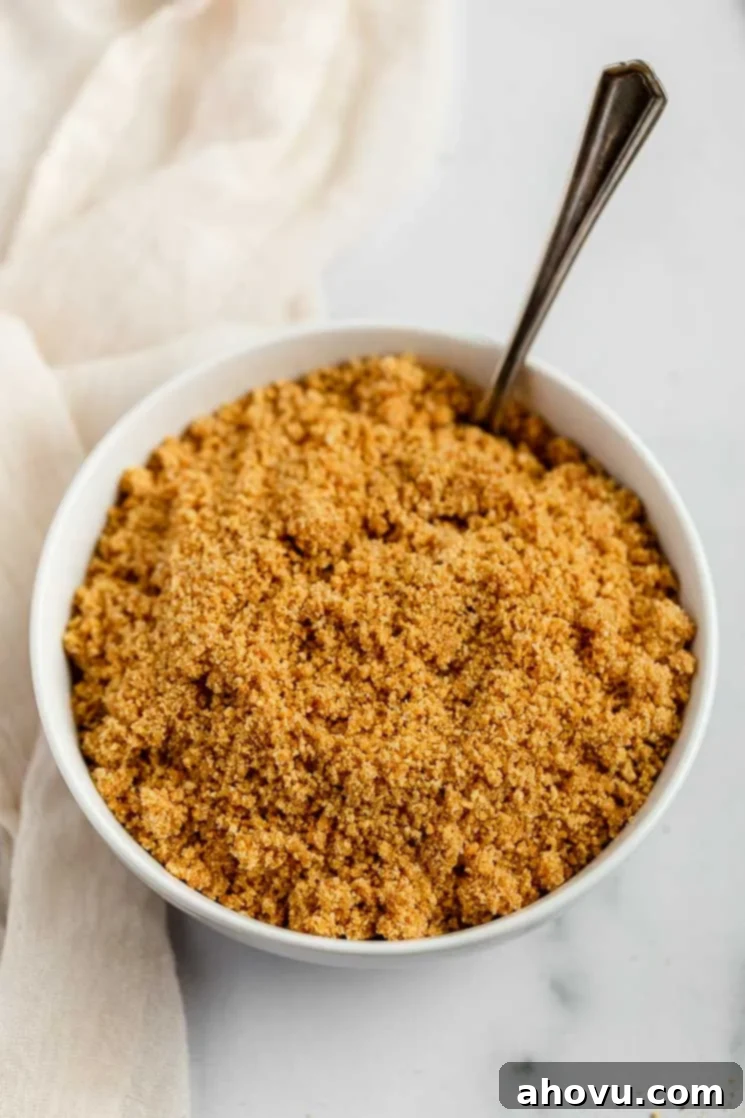 Perfect Homemade Graham Cracker Crust 4 A mixture of graham cracker crumbs, sugar, and melted butter perfectly combined in a white mixing bowl.