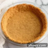Perfect Homemade Graham Cracker Crust 8 A golden-brown graham cracker crust pressed firmly into a glass pie dish, awaiting its delicious filling.