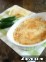 Close-up of a perfectly baked Jalapeno Cream Cheese Dip, golden and bubbly, ready to be served.