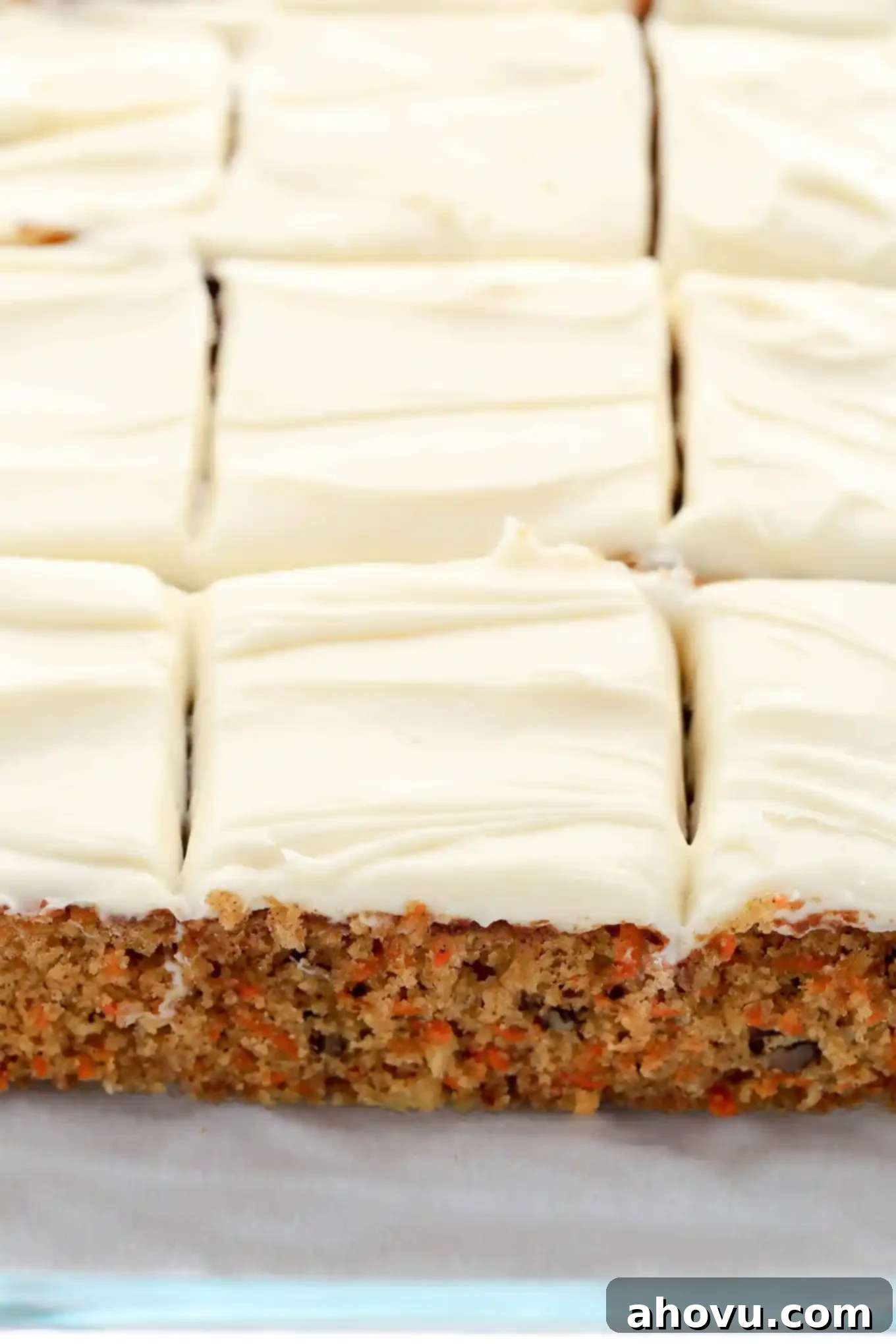 Sun-Kissed Pineapple Carrot Cake 3 A beautifully baked homemade carrot cake with pineapple, sliced into generous portions and ready to serve.