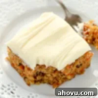 Sun-Kissed Pineapple Carrot Cake 6 A top-down view of the frosted pineapple carrot cake, showing its moist texture and walnuts.