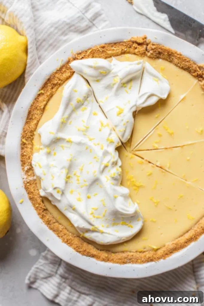 Golden Citrus Dream 2 A lemon pie in a white baking dish topped with whipped cream and lemon zest.