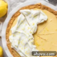 Golden Citrus Dream 7 A lemon pie in a white baking dish tipped with whipped cream and lemon zest.