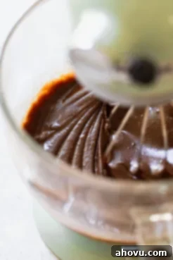 The dry ingredients and wet ingredients mixed together in a glass bowl.