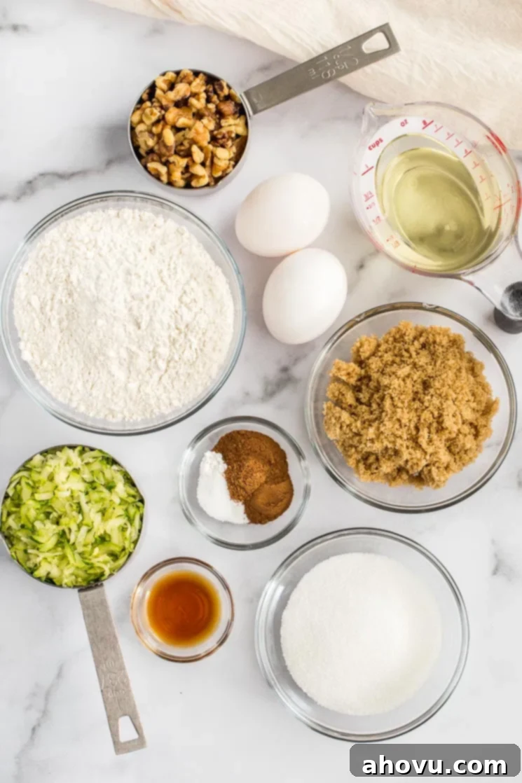 Grandma's Zucchini Bread 3 The ingredients needed for zucchini bread sitting on top of a marble surface.