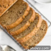 Grandma's Zucchini Bread 6 A sliced zucchini bread on top of a marble surface.