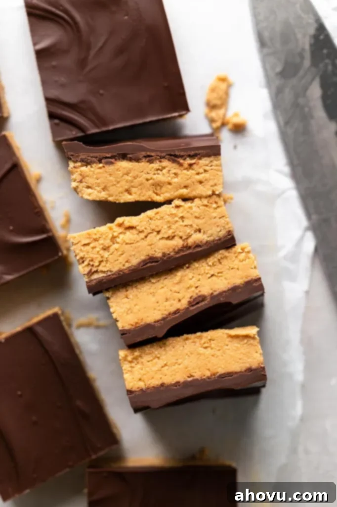 Effortless Peanut Butter Chocolate Treats 4 Four slices of chocolate peanut butter bars, lying on their sides. Unsliced bars surround them.