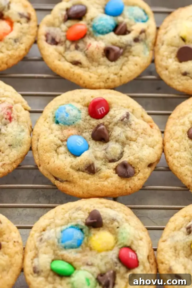 Chocolate chip M&M's cookies cooling on a wire rack. 