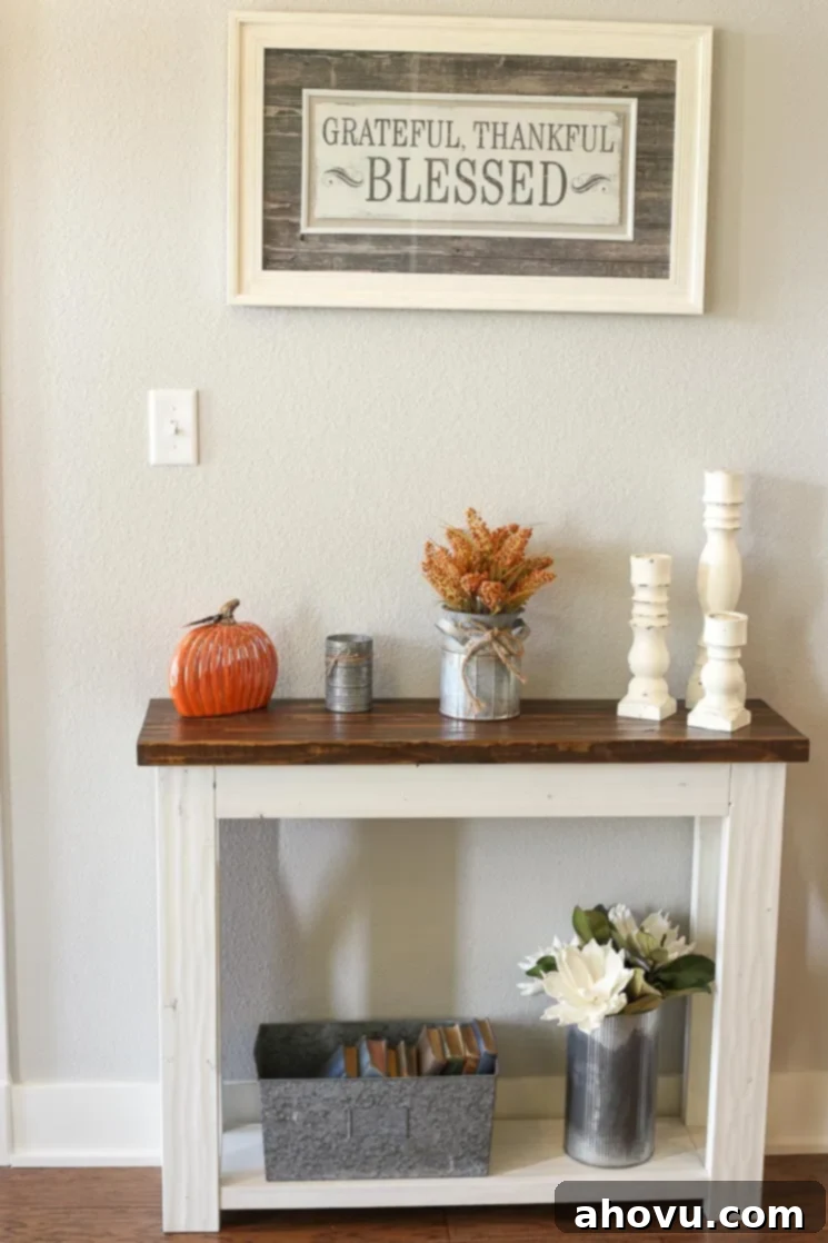 A rustic farmhouse entry table, distressed and custom-built, in a bright entryway.