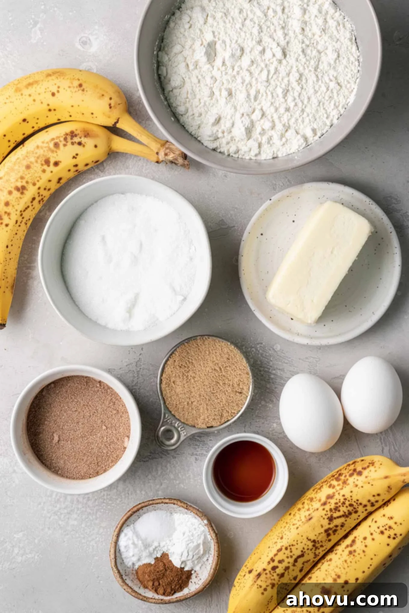 An overhead view of the fresh ingredients perfectly arranged for making homemade cinnamon banana bread.
