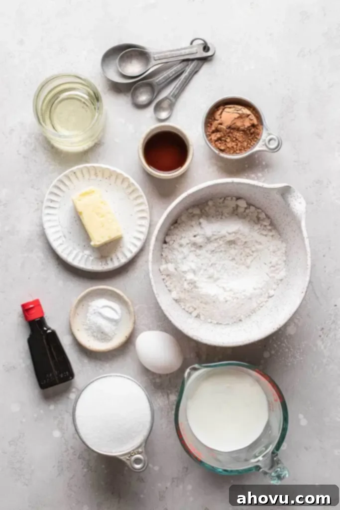 Velvety Red Delights 3 An overhead view showcasing all the essential ingredients meticulously laid out for baking red velvet cupcakes, including flour, cocoa powder, butter, eggs, buttermilk, red food coloring, and the components for cream cheese frosting.