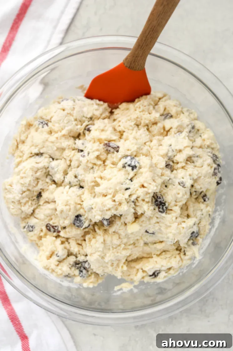 A clear glass bowl filled with Irish Soda Bread dough sitting on top of a red and white napkin. 