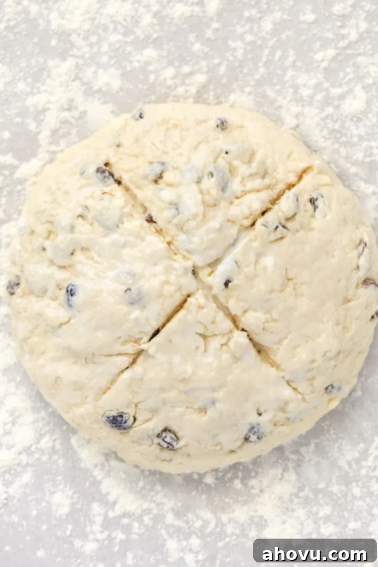 A loaf of Irish Soda Bread with an 'X' cut in the top.