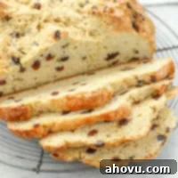 A sliced loaf of Irish Soda Bread on top of an antique round cooling rack.