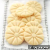 A group of shortbread cookies piled onto an antique safety grater.
