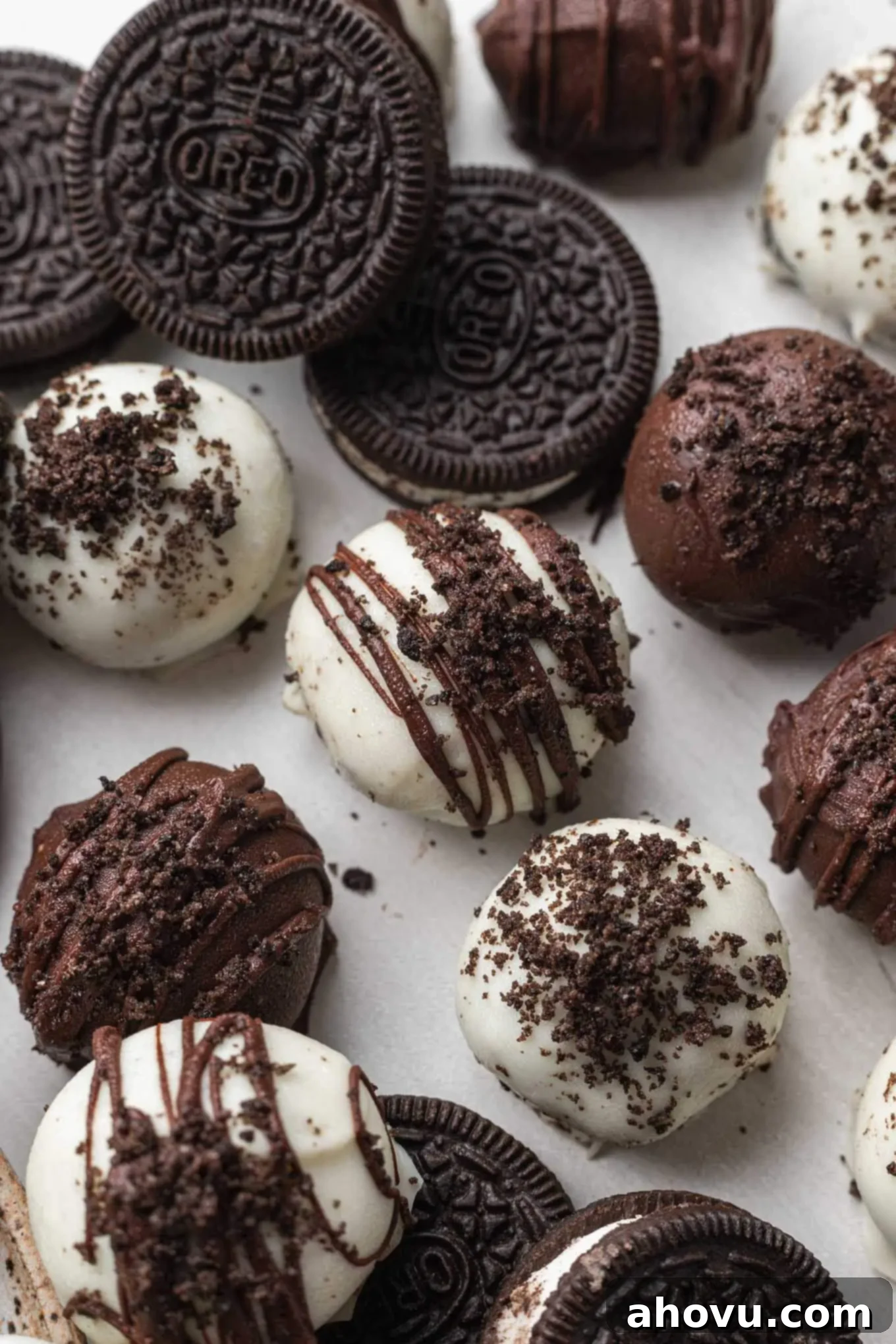 Velvet Oreo Truffles 6 A close-up, overhead view of Oreo cookie balls next to actual Oreo cookies.