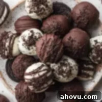 Velvet Oreo Truffles 7 A plate with several Oreo balls covered in white chocolate and semi-sweet chocolate.