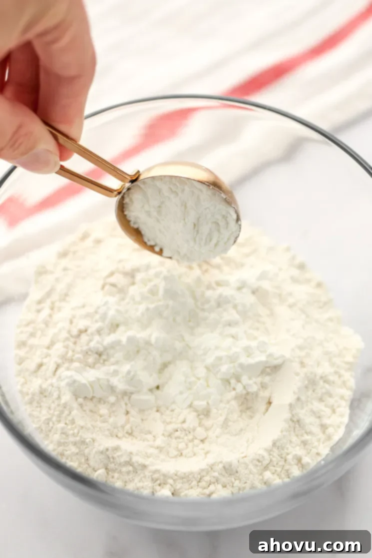 A glass bowl filled with all-purpose flour and two tablespoons of cornstarch.