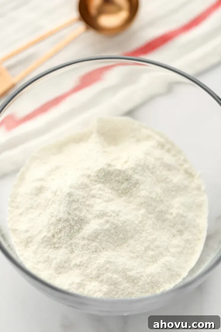 A clear glass bowl filled with sifted homemade cake flour.
