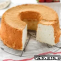 A beautifully golden-brown angel food cake resting on a wire rack after being baked to perfection.