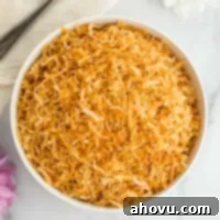 A white bowl filled with toasted coconut.