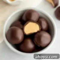 A small white bowl filled with peanut butter balls.