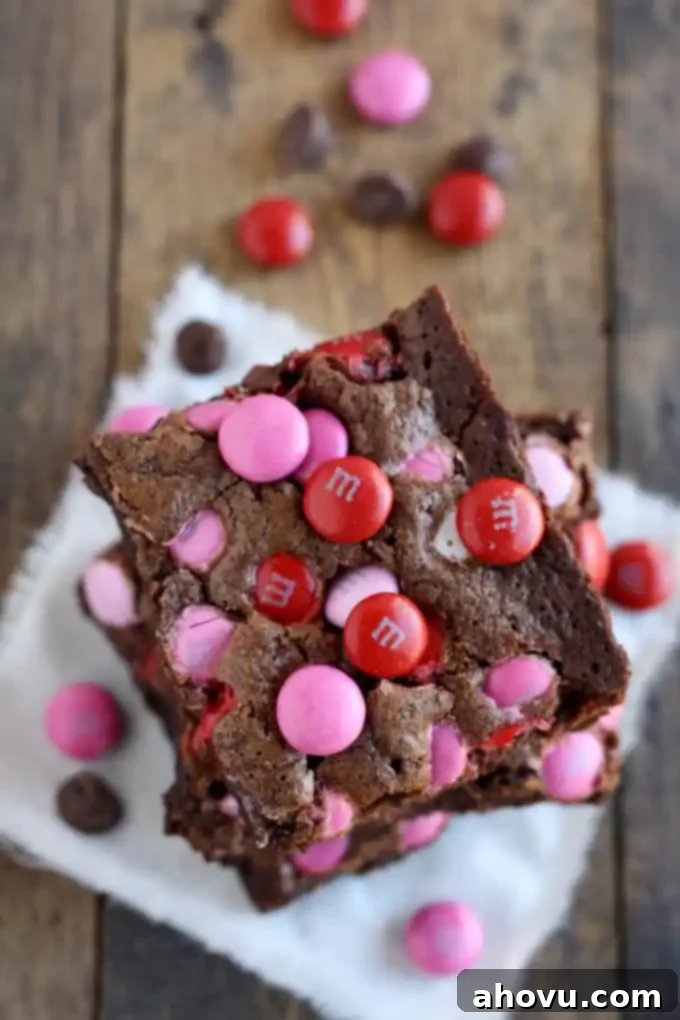 Overhead view of a stack of three Valentine's Day brownies on a square of fabric.