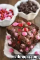 A top-down view of a plate with a fudgy M&M's brownie, showcasing its rich chocolate color and colorful candies.