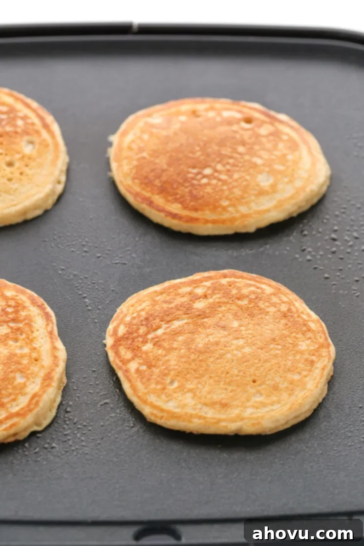 Wholesome Wheat Stacks 4 A black grilled topped with fully cooked whole wheat pancakes.