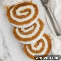 Autumn Spice Swirl 7 A sliced pumpkin roll dusted with powdered sugar.