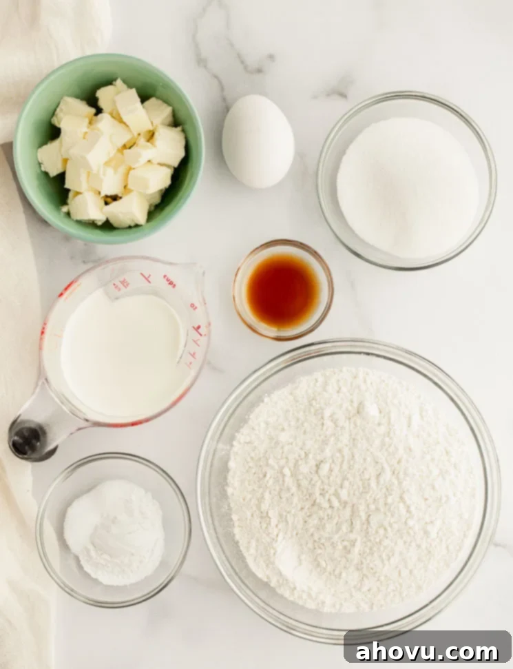 All the essential ingredients for making fluffy scones, precisely measured into clear glass bowls and arranged neatly on a smooth marble surface.