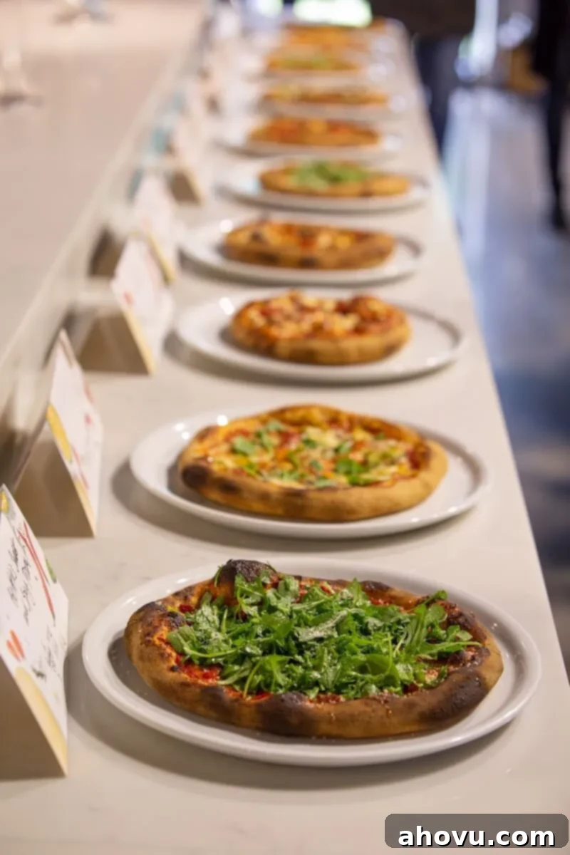 A picture of different pizzas lined up in a row.