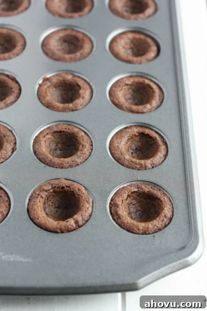 Mint Chocolate Cookie Treats 4 Close-up of baked chocolate cookie cups with perfect indentations for frosting, cooling on a wire rack.